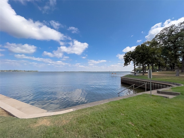 dock area featuring a water view and a lawn