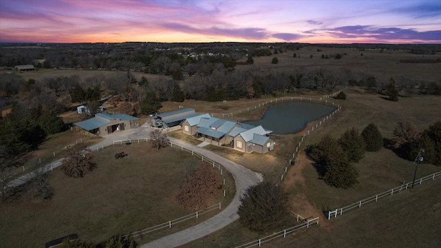 aerial view at dusk featuring a rural view