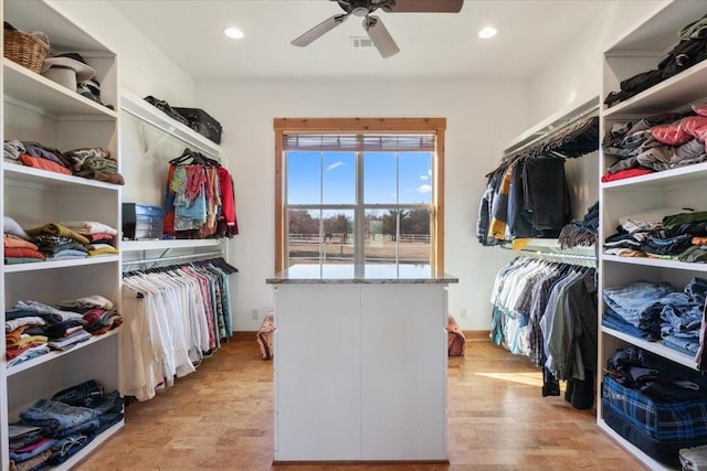 walk in closet featuring ceiling fan