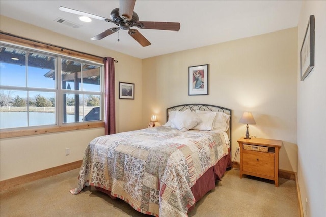 bedroom featuring a water view and ceiling fan