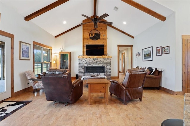 living room featuring beamed ceiling, ceiling fan, a stone fireplace, and high vaulted ceiling