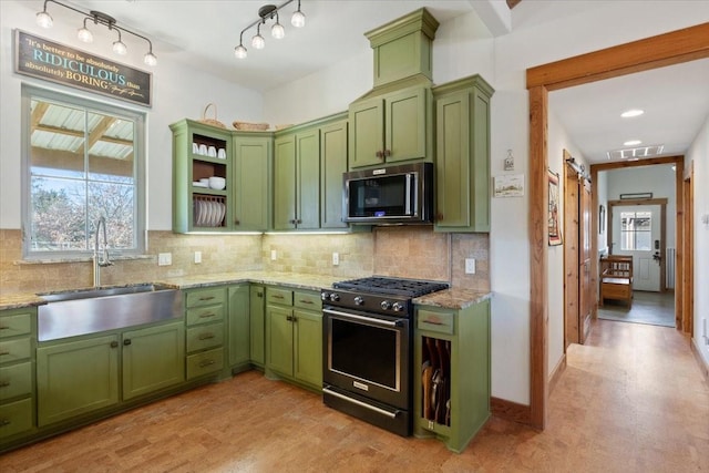 kitchen featuring sink, light stone countertops, green cabinetry, and appliances with stainless steel finishes