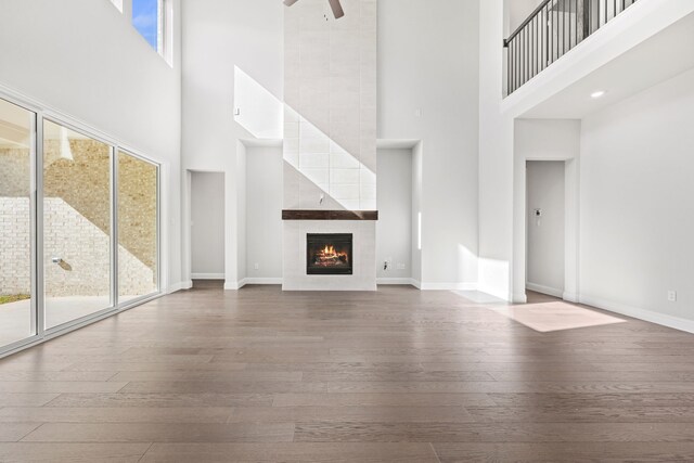 kitchen featuring appliances with stainless steel finishes, a kitchen island with sink, dark wood-type flooring, a notable chandelier, and white cabinets