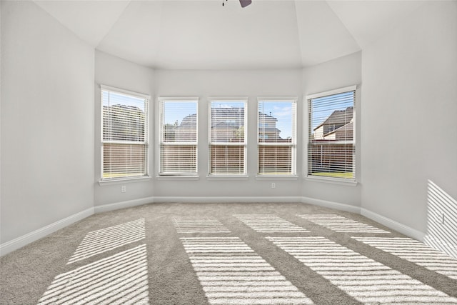 unfurnished sunroom featuring vaulted ceiling, a wealth of natural light, and ceiling fan