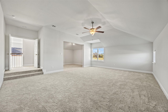 carpeted empty room featuring ceiling fan and lofted ceiling