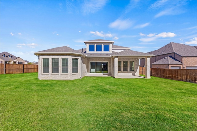 rear view of property featuring a yard and a patio