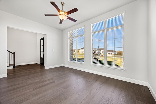 spare room featuring dark hardwood / wood-style flooring and ceiling fan