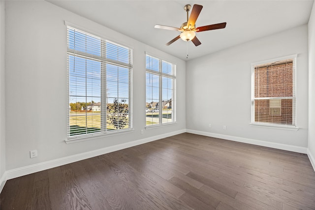 spare room featuring dark hardwood / wood-style flooring and ceiling fan