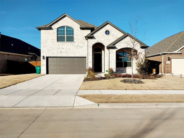 french country style house with a garage