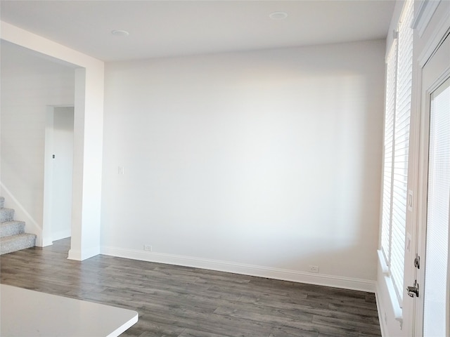 spare room with dark wood-type flooring