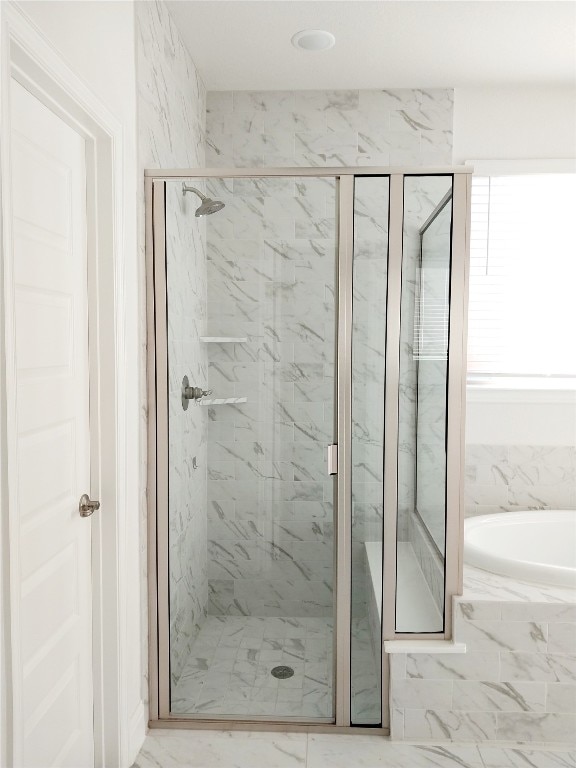 bathroom with tile flooring and independent shower and bath