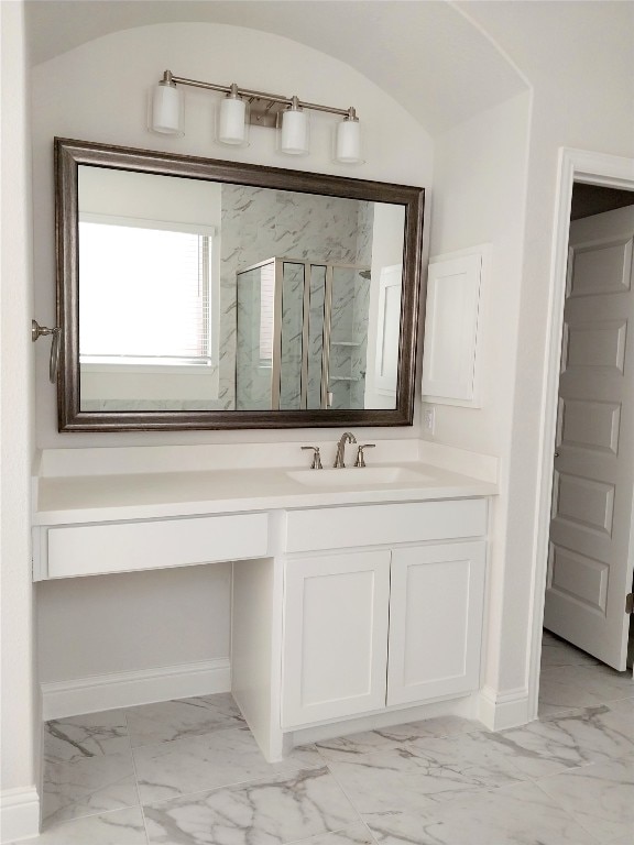 bathroom featuring tile floors, vanity, and vaulted ceiling