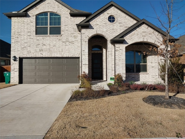 french country style house with a garage