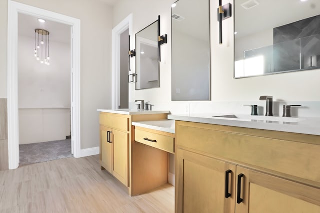 bathroom with hardwood / wood-style flooring and vanity