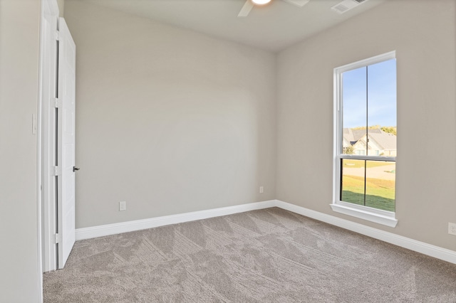 unfurnished room with light carpet, a healthy amount of sunlight, and ceiling fan