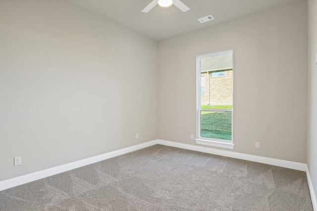 carpeted spare room featuring ceiling fan