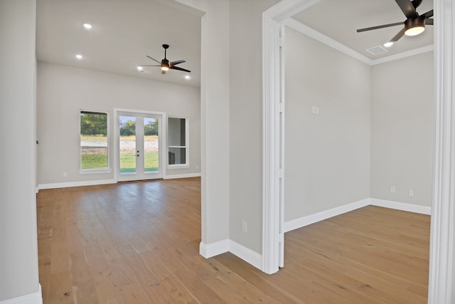 spare room with crown molding, ceiling fan, french doors, and light hardwood / wood-style flooring