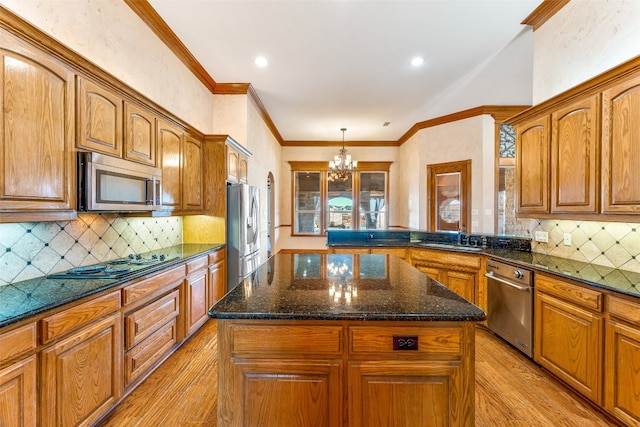 kitchen featuring light hardwood / wood-style floors, stainless steel appliances, an inviting chandelier, and a center island