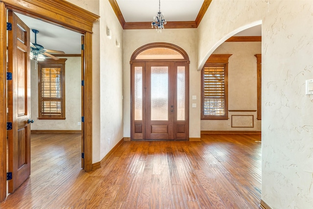 foyer with ornamental molding, ceiling fan, and hardwood / wood-style floors