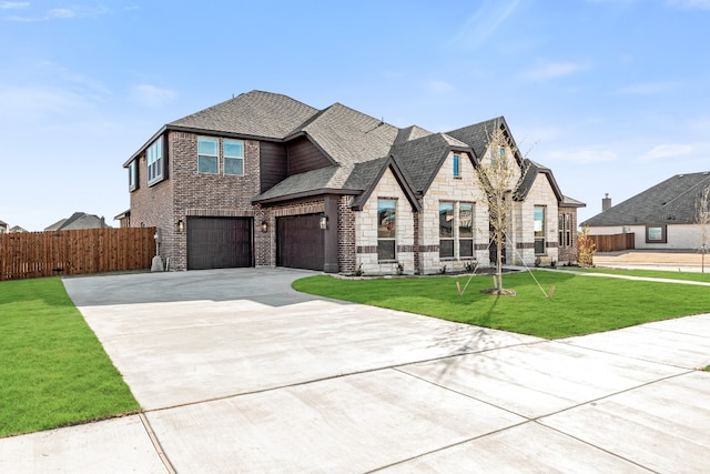 view of front of property featuring a front lawn and a garage