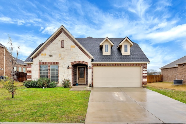 view of front of home with a front lawn, a garage, and cooling unit