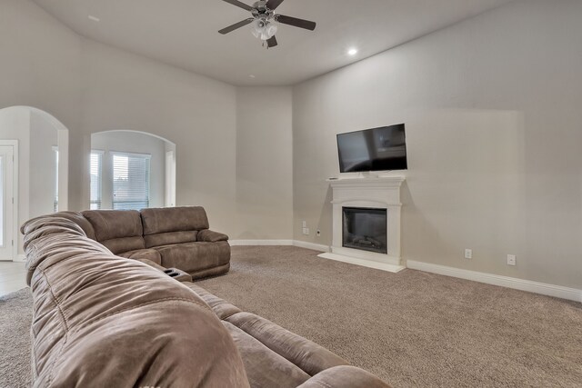 living room featuring ceiling fan and light colored carpet