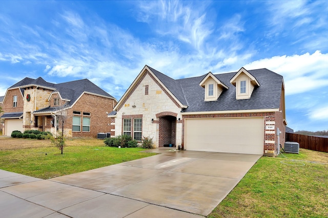 view of front of home with central AC unit and a front lawn