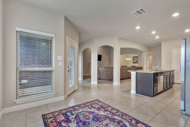 interior space with sink and light tile patterned floors