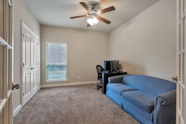 office space with ceiling fan and light carpet