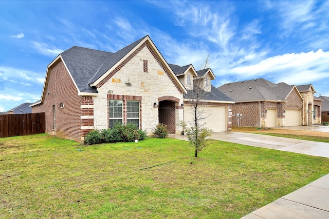 french provincial home featuring a garage and a front lawn