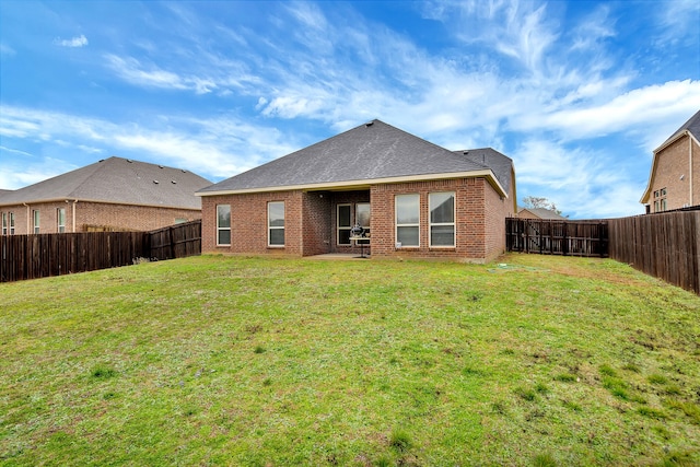 rear view of property featuring a yard