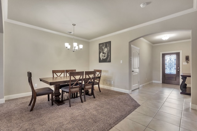 tiled dining room with crown molding and an inviting chandelier