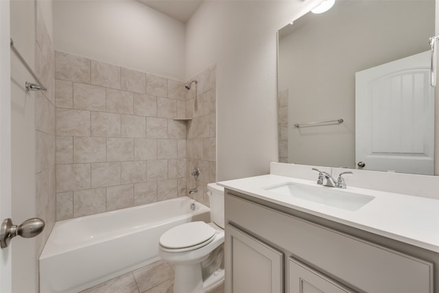 full bathroom with tile patterned floors, vanity, tiled shower / bath combo, and toilet