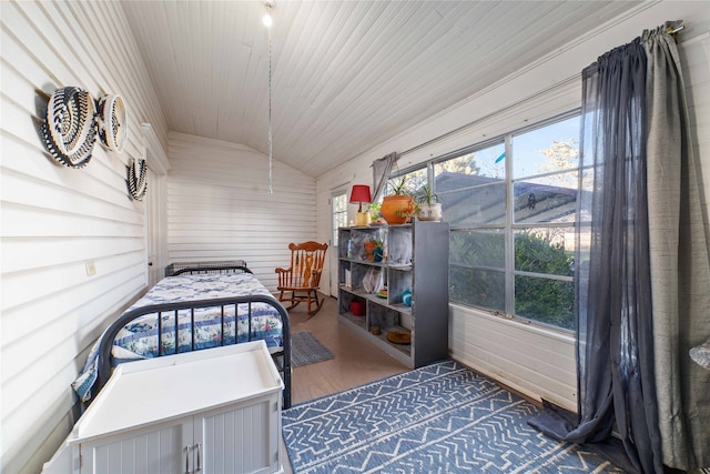 bedroom with crown molding, lofted ceiling, and hardwood / wood-style floors