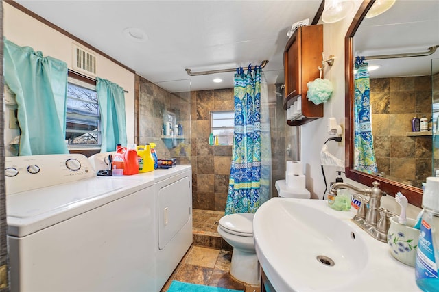 bathroom with a shower with curtain, toilet, washer and dryer, vanity, and tile patterned floors