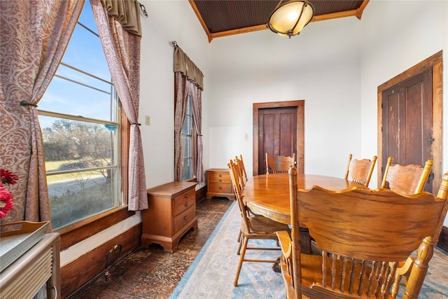 dining area featuring crown molding and wood ceiling