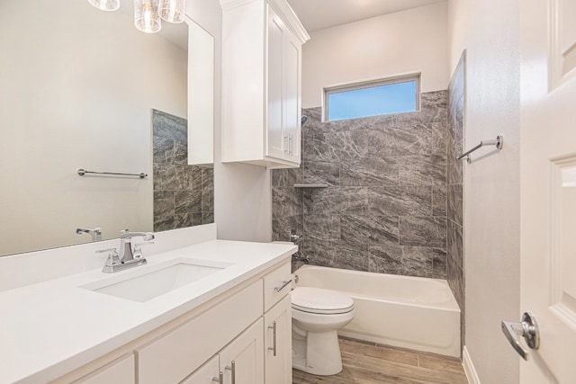 full bathroom featuring hardwood / wood-style floors, toilet, shower / bathing tub combination, and vanity