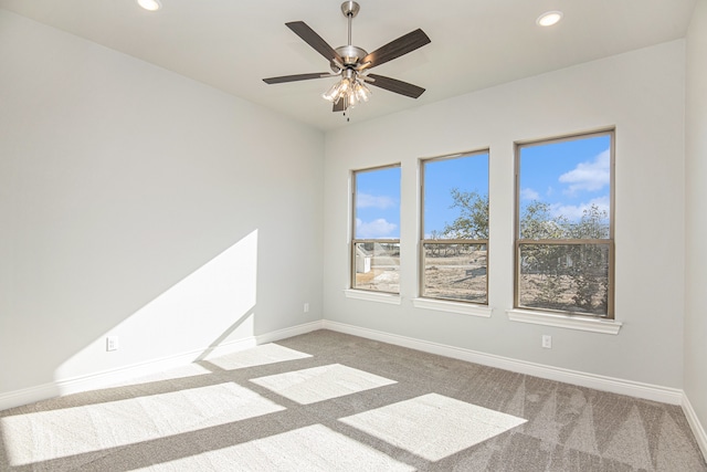 empty room with ceiling fan and carpet