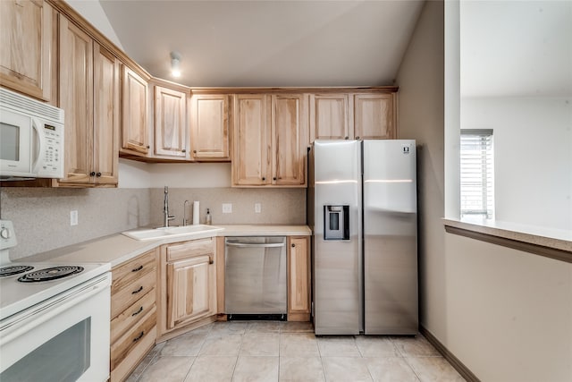 kitchen with light brown cabinets, stainless steel appliances, and sink