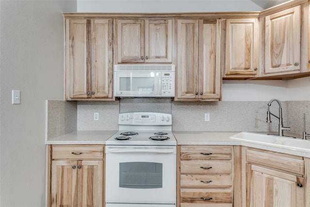 kitchen featuring light brown cabinets, sink, and white appliances