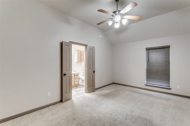 carpeted empty room with ceiling fan and lofted ceiling