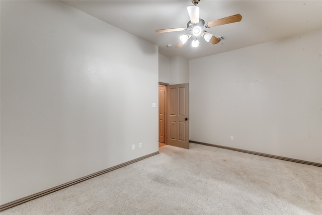 spare room featuring ceiling fan and light colored carpet