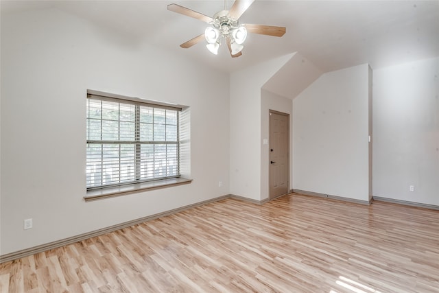 empty room featuring ceiling fan, light hardwood / wood-style flooring, and lofted ceiling