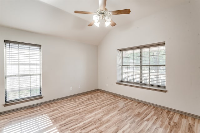 spare room featuring ceiling fan, lofted ceiling, and light wood-type flooring