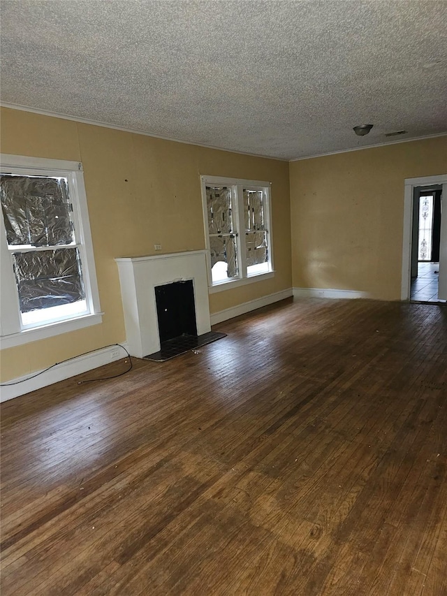 unfurnished living room with visible vents, a fireplace, a textured ceiling, and hardwood / wood-style flooring