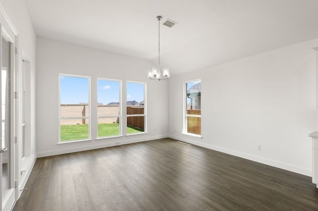 unfurnished dining area featuring a chandelier and dark hardwood / wood-style flooring