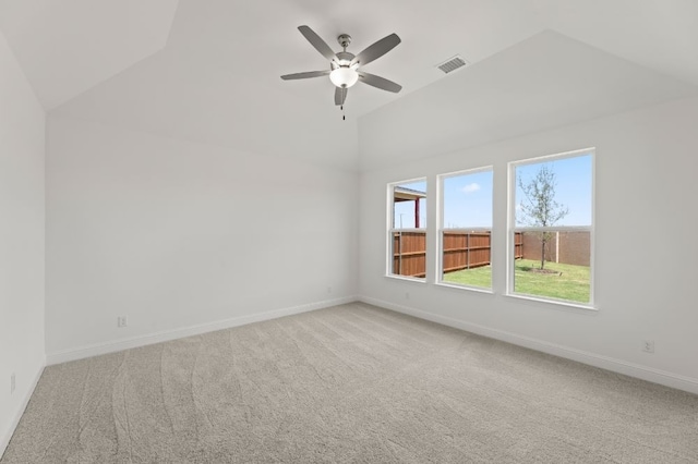 carpeted empty room with ceiling fan and lofted ceiling