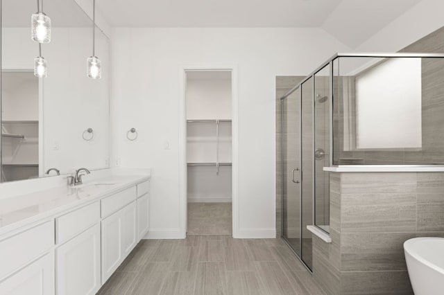 bathroom featuring vanity and plus walk in shower