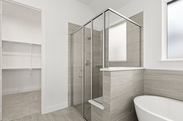 bathroom featuring separate shower and tub