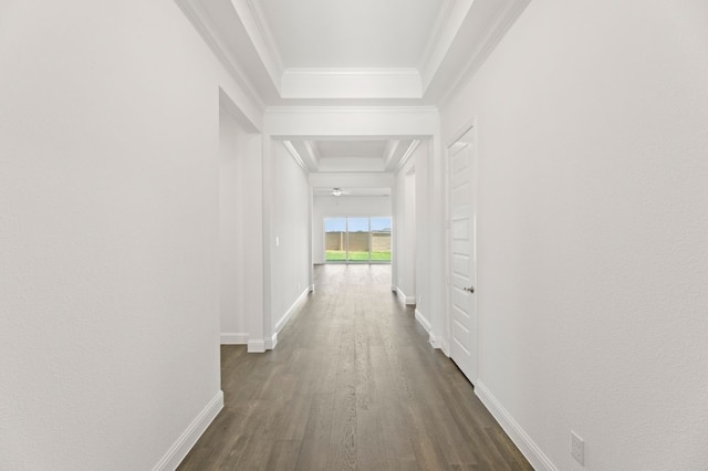 hall with dark wood-type flooring and crown molding